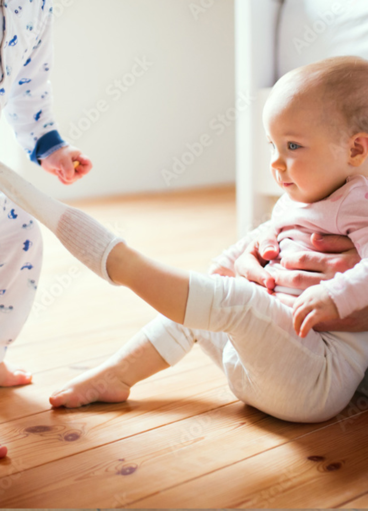 baby crawling on floor with mom